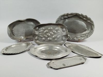 several pieces of silverware sitting on top of a white surface