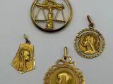 a group of four gold pendants including a lady, a lady, and a lady