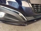 a close up of a car ' s front bumper and headlight