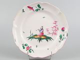 an image of a plate with a bird and flowers on it