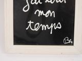 a chalk board with writing on it in a white frame