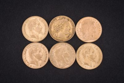 six different types of coins are shown on a black surface
