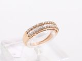 a close up of a diamond ring on a clear stand