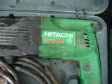 a green and black electric drill in a case