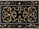 a black area rug with a floral design on it