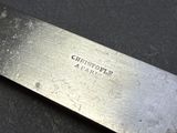 a close up of a knife on a black surface