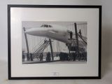 black and white photograph of a plane being loaded with passengers