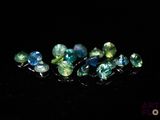 a close up of a group of gems on a black surface