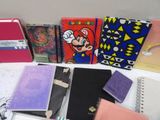 many notebooks that are lined up on a table