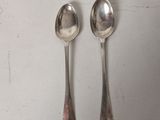 two spoons sitting next to each other on a table