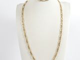 a white mannequin torso with a gold chain necklace on it