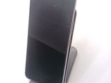 a cell phone that is sitting on top of a stand