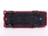 a red toy car that is sitting on a white surface
