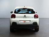 the rear of a white citrole parked in a white room