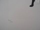 a black cat that is standing on a white wall