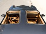 a view from above of a black sports car driving down the street