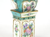 a blue and white teapot with flowers on it