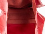 the inside of a red leather bag with a zipper