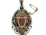 an image of a pendant with a stone in the middle and a chain around it