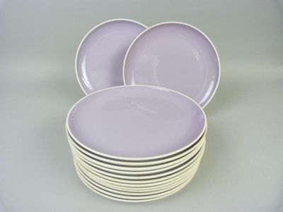 purple plates stacked on top of each other on a table
