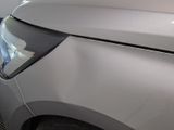 a close up of a car ' s headlight and front bumper