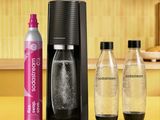 a close up of a bottle of soda next to two bottles of soda