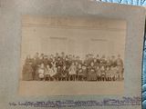 an old photo of a group of people posing for a picture