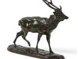 une image représentant une statue en bronze d'un cerf posé sur un rocher