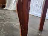 a close up of a wooden table with peeling paint on it