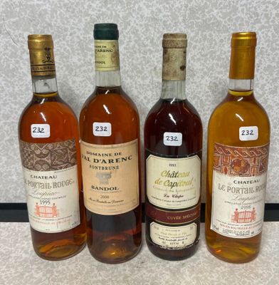 quatre bouteilles de vin sont alignées sur une table