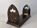 a wooden bookend with a clock on top of it
