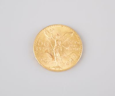 a close up of a gold coin on a white surface