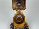 a small vase that has a gold and blue design on it