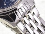a close up of a watch with a blue face