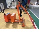 a fork lifter sitting on the floor in a warehouse