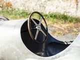 a silver race car with a steering and a steering wheel