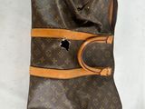 a brown bag and a pair of shoes on a white surface