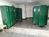 several green lockers are lined up in a row in a room