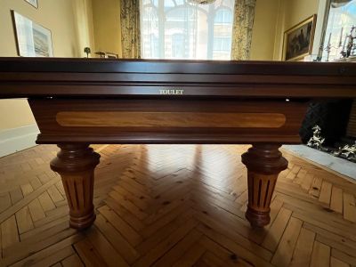 une table de billard placée au milieu d'une pièce