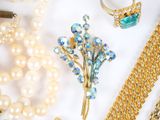 many different types of jewelry on a white surface