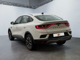 the rear end of a white car parked in a garage