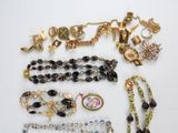 several pieces of jewelry including a necklace, bracelet, and broochet