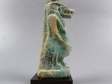 an image of a statue of a horse on a wooden base