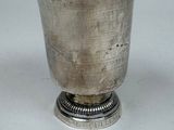 a silver cup that is sitting on top of a table