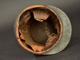 a close up of a small vase with a hole in it
