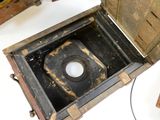 an old wooden box with a hole in it