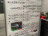 a display of glasses on the wall in a store