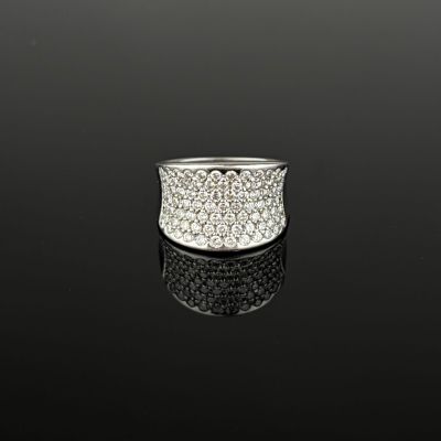 a close up of a diamond ring on a black surface