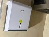 a paper towel dispenser attached to the wall