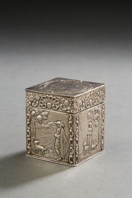 an old silver box sitting on top of a table next to a black background